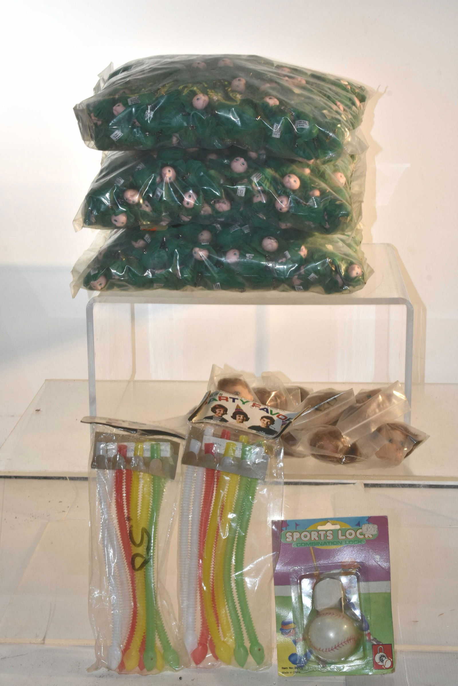 Mixed Children's Grouping: Lot includes (2) large bags of Cabbage Head doll pins, (2) bags of party's favor snake whistles, rubber doll heads, and a baseball padlock.