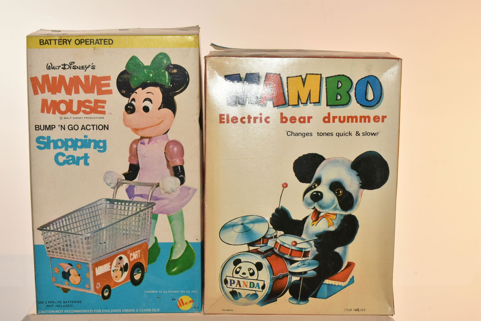 Battery Operated Minnie Mouse and Mambo: Lot includes Minnie Mouse Bump 'N Go shopping cart , which is battery operated, and Mambo battery operated electric bear drummer. Both items are in box.