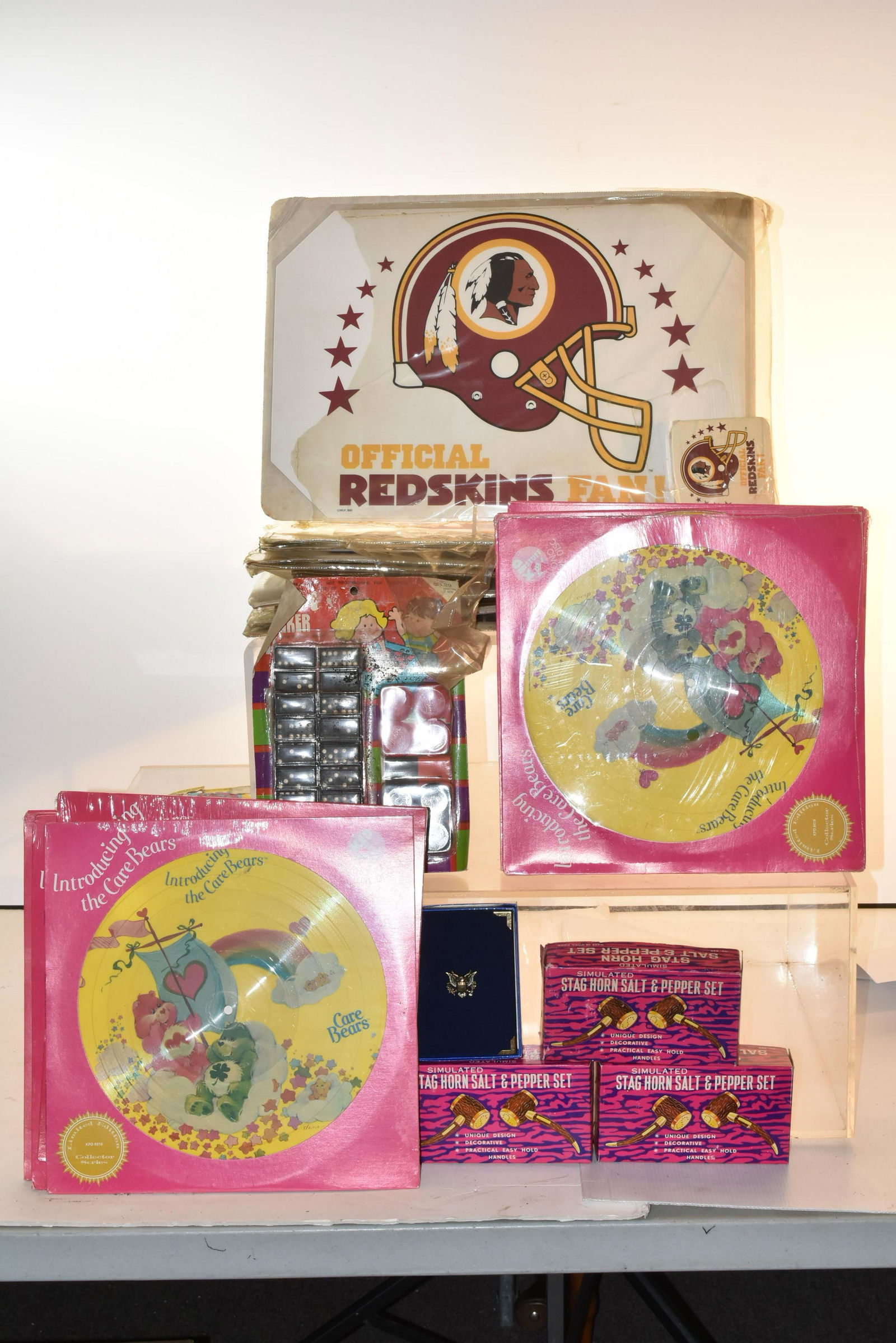 Washington Redskins Items, and More: Lot includes (12) Redskins table mats and coaster sets, Care Bear records, simulated stag horn salt and pepper sets, and more.