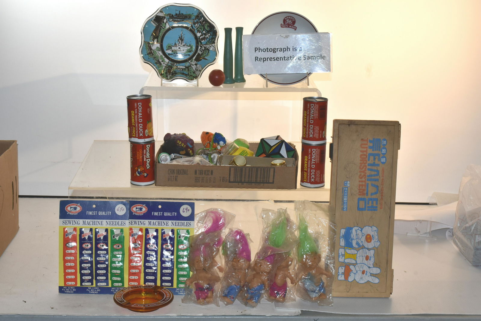 Troll Dolls, Needle Packs and More: Lot includes (12) troll dolls in bags, (2) General Store needle pack displays, Walt Disney ashtray, wooden blocks and more.