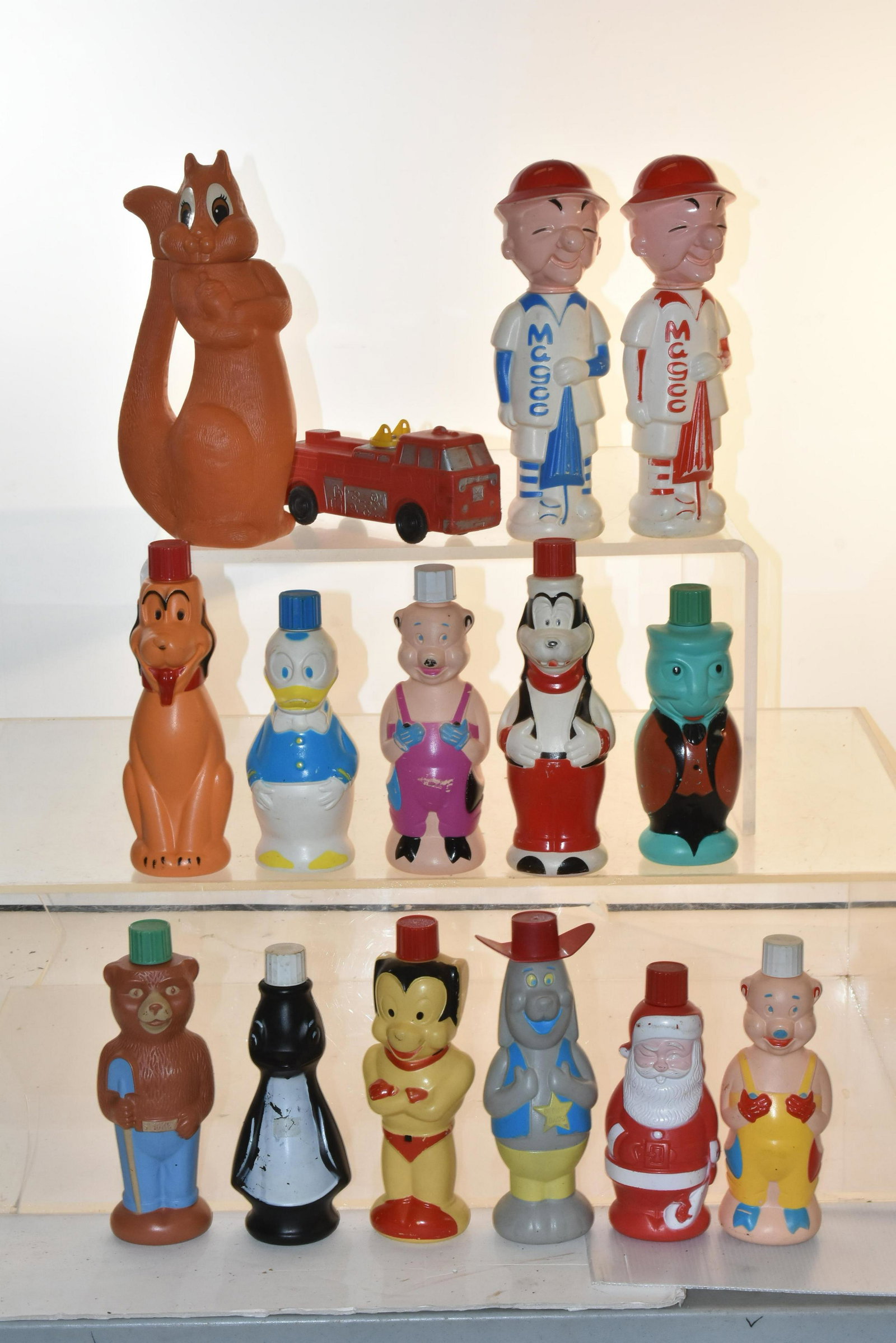 Collection of Soaky Shampoo Bottles: Lot includes (2) Mr. Magoo, a Deputy Dog, all complete, and (11) Soakys with caps and no hats, and an unrelated squirrel shampoo bottle.