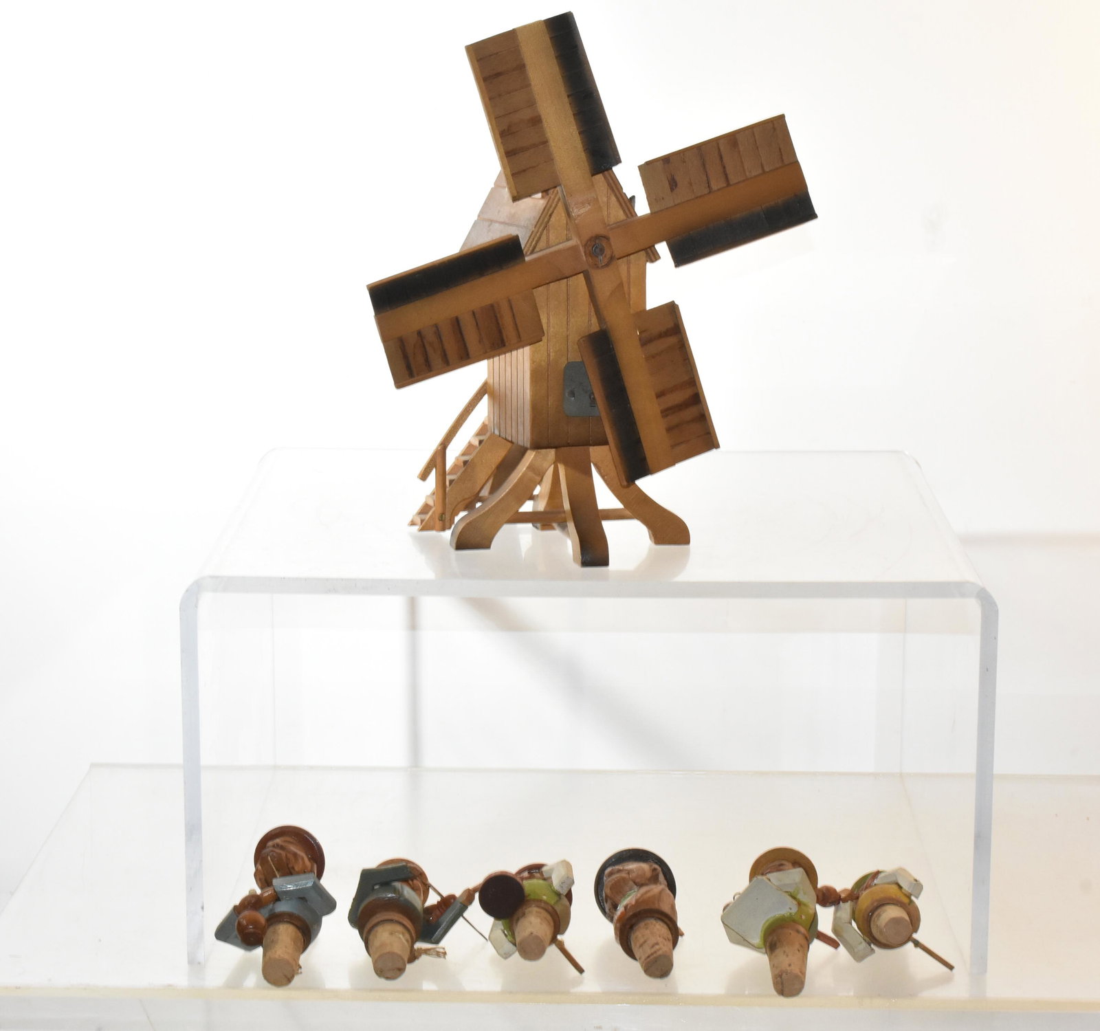 German Windmill Music Box and Bottle Stoppers: Item measures approximately 11"H to top of propeller. It is fully functional. Lot also includes (6) hand painted bottle stoppers. Some still function.
