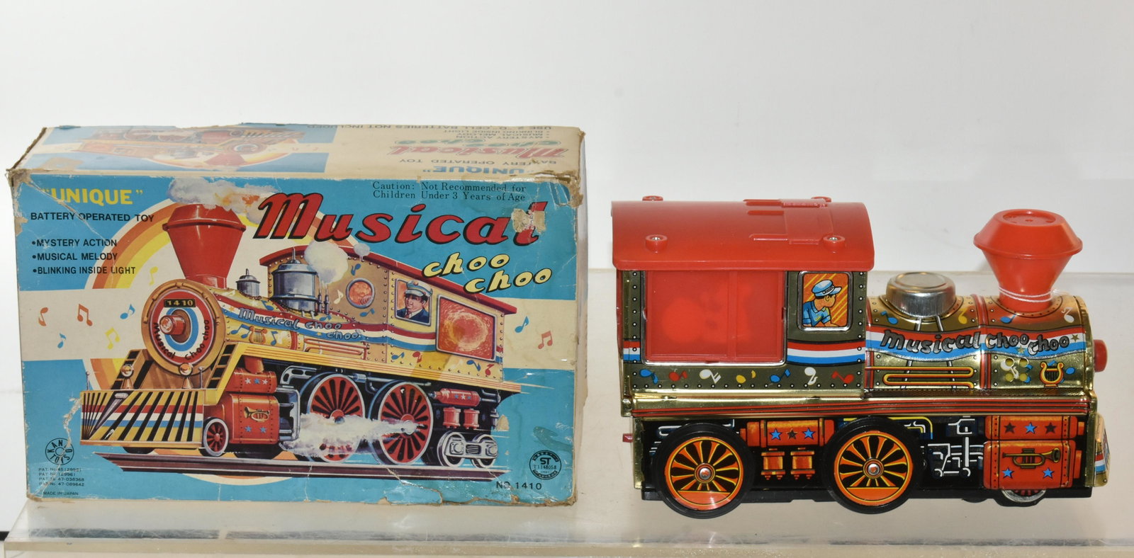 Battery Operated Musical Choo Choo Train: Item measures approximately 9"L. It has clean graphics, it is in delicately used condition. It was produced by ST Toys, Japan. It has original box, box shows wear.