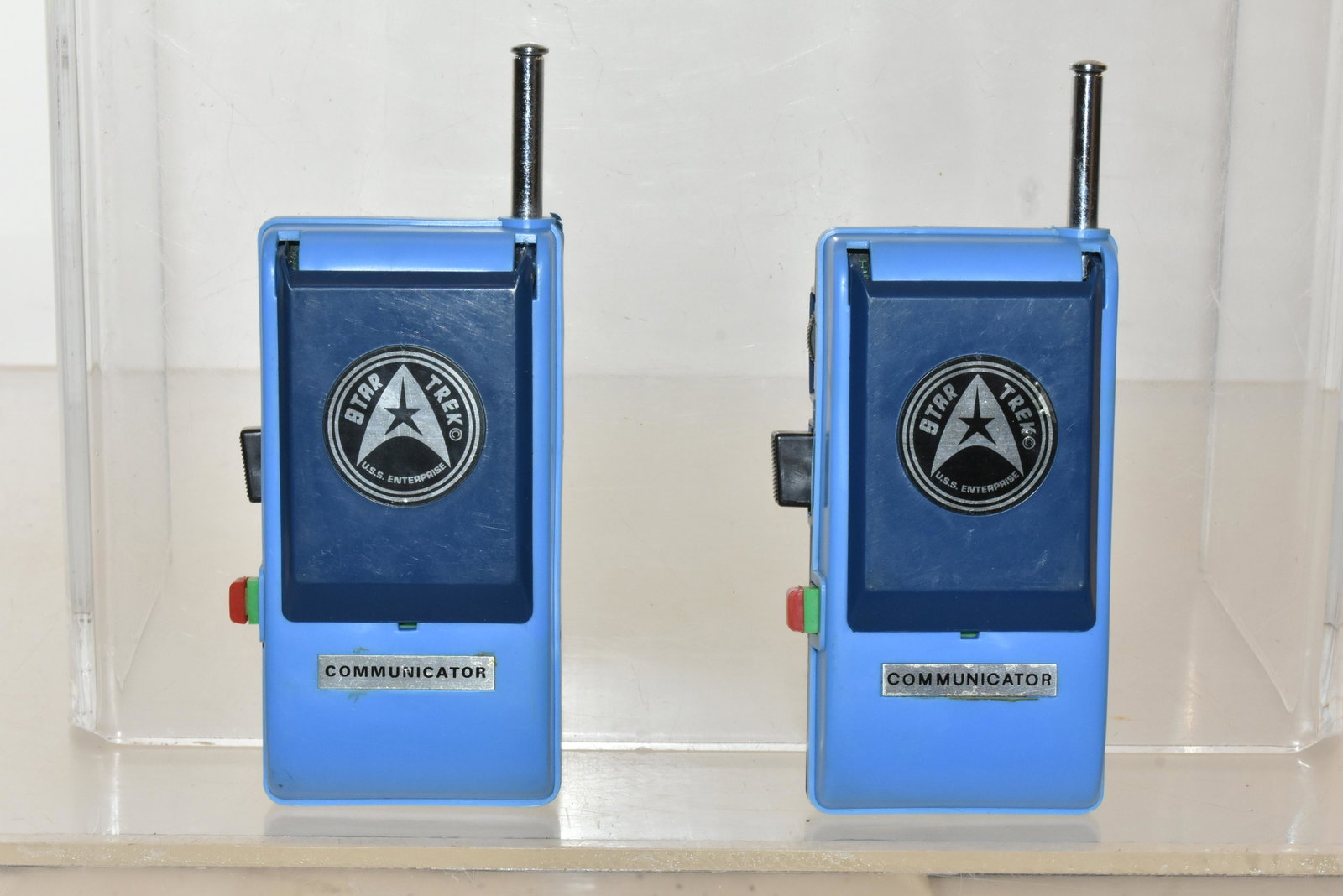 Pair of Star Trek Communicators: Each measures approximately 5.5"H not including antenna. The latches work on both communicators. The push talk buttons are functional. They were produced in 1974 by Migo, for Paramount Pictures Corp.