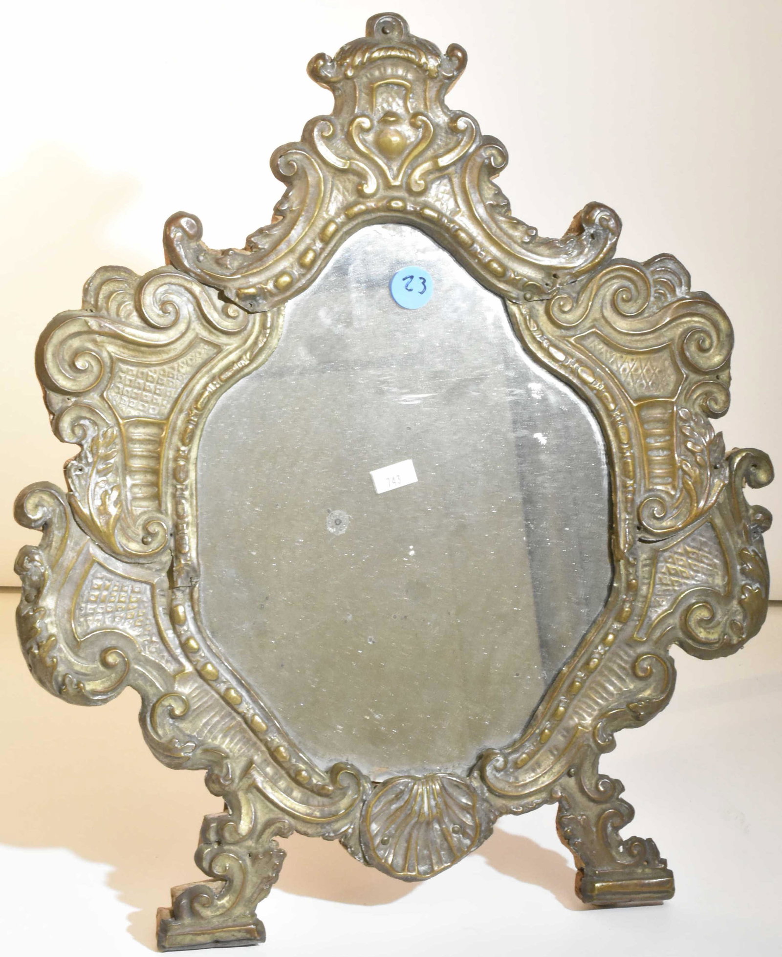 19th C Venetian Brass Over Wood Looking Glass: Item measures approximately 16"H. It is pressed brass over hand cut pine. The looking glass / mirror appears to be original. It has a stand on back that is original. The hinge pin has been replaced wi