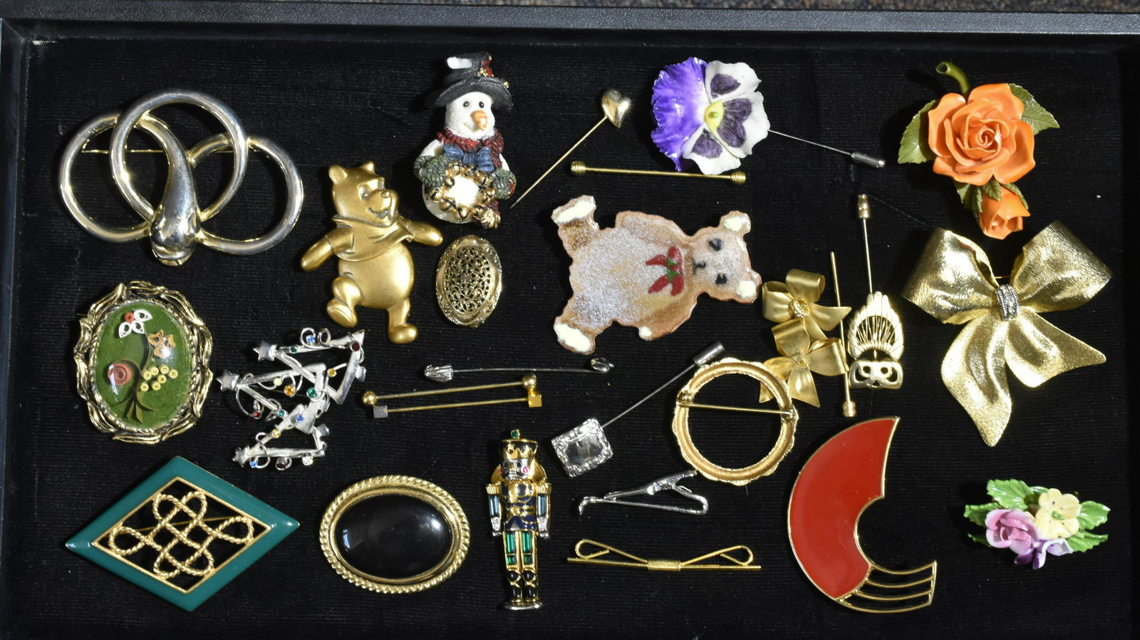 Collection of Brooches and Pins: Lot includes Capodimonte floral brooches, various stick pins, an enamel bear pin, and more.