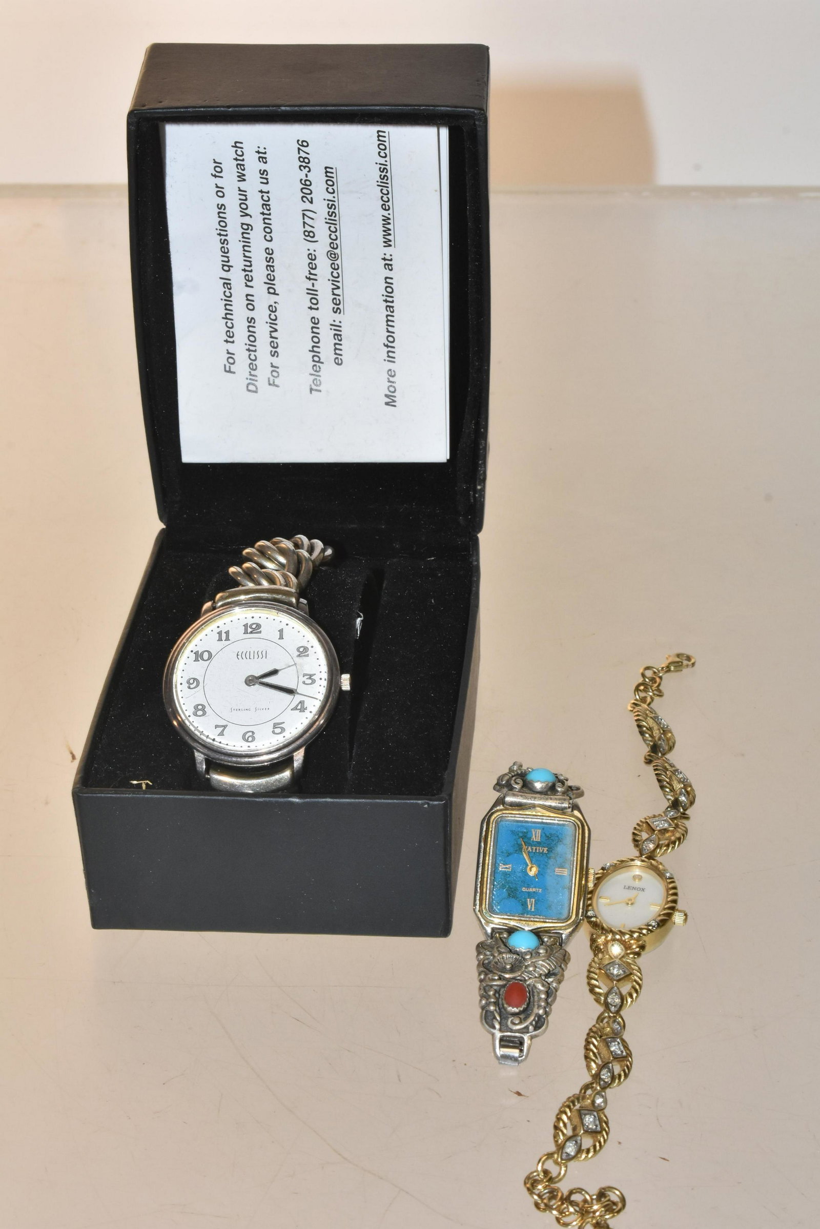 Sterling and Lenox Watches: Lot includes an Ecclissi sterling silver wristwatch in box, a native wristwatch with sterling turquoise and coral on band, and a ladies' Lenox wristwatch.