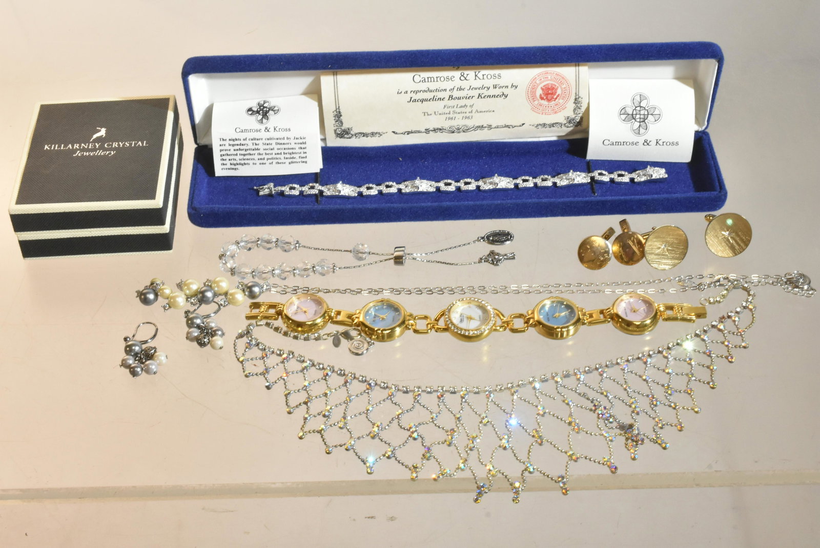 Sterling Camrose and Kross Bracelet and More: Lot includes a Jackie Kennedy replica sterling and CZ tennis bracelet, a Kirk's Folly crystal necklace, cufflinks, a watch, and earrings.