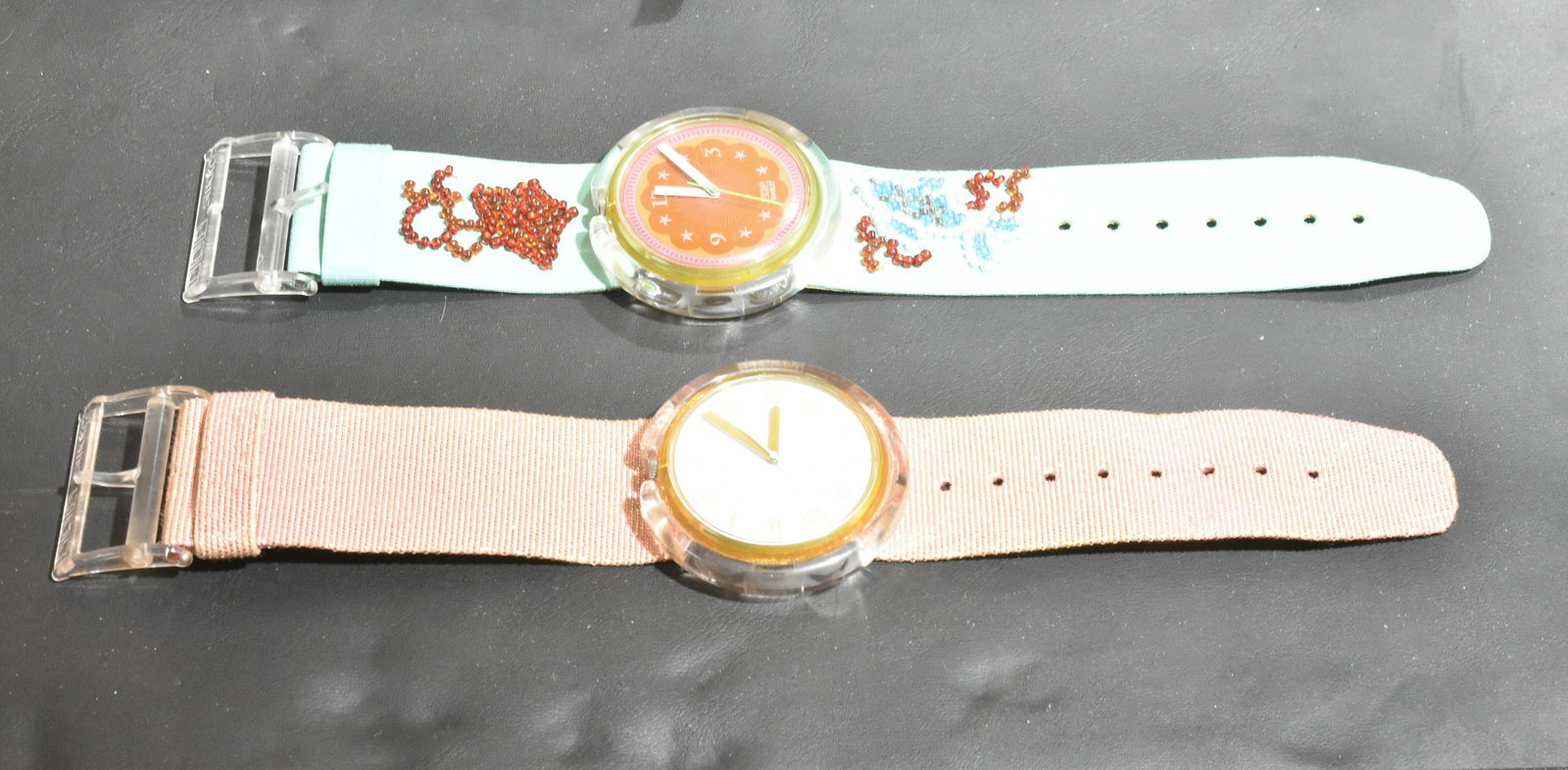 Swatch Special Edition Pop Watches: Lot includes 1991 French watch with pink glitter leather band, and a 1992 ocean motif beaded band watch, with pink face.