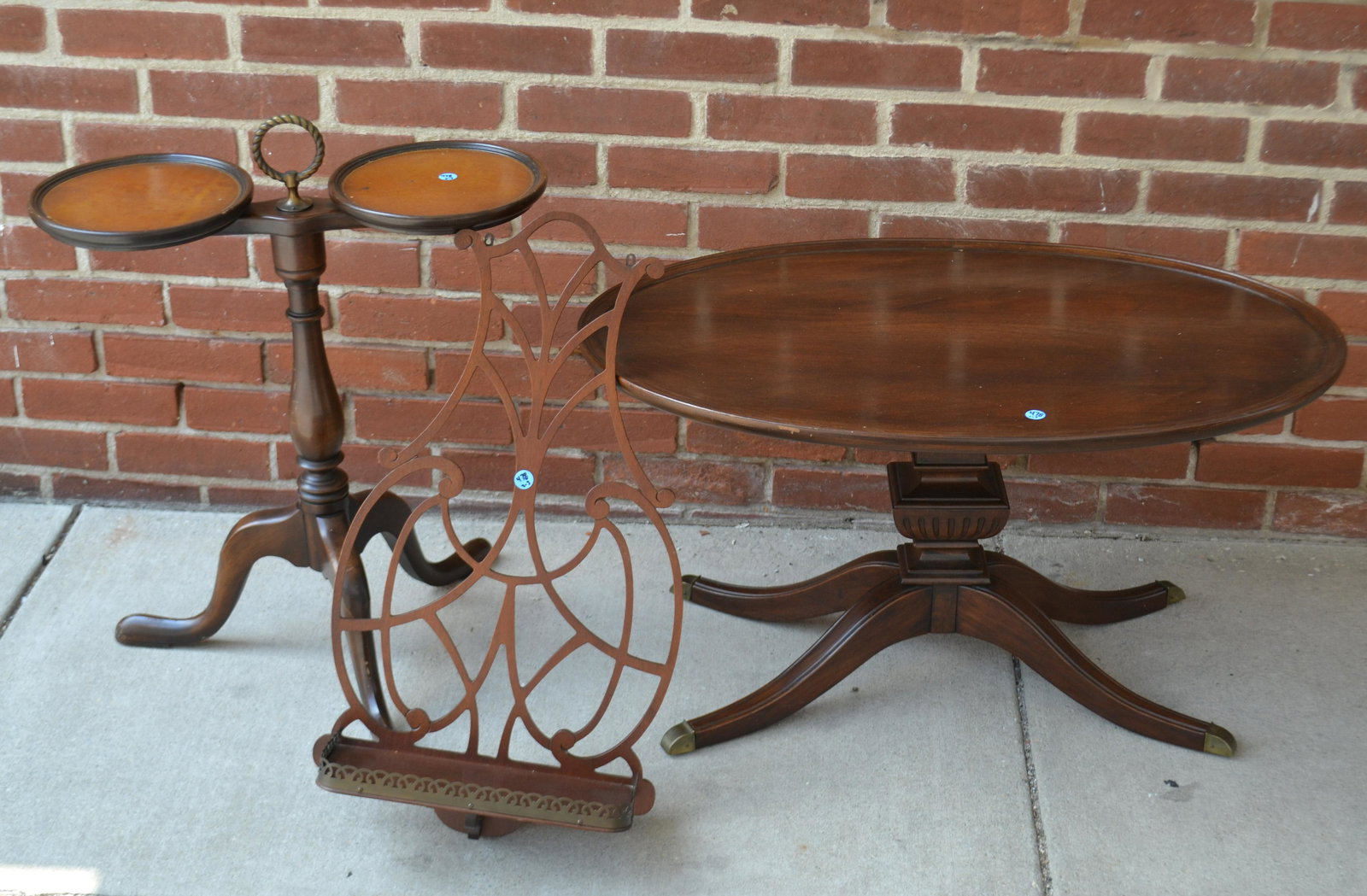 Mahogany Furniture Grouping: Lot includes a double plant stand with leather top, an oval coffee table with Duncan Phyfe base, and a wall shelf with brass gallery.