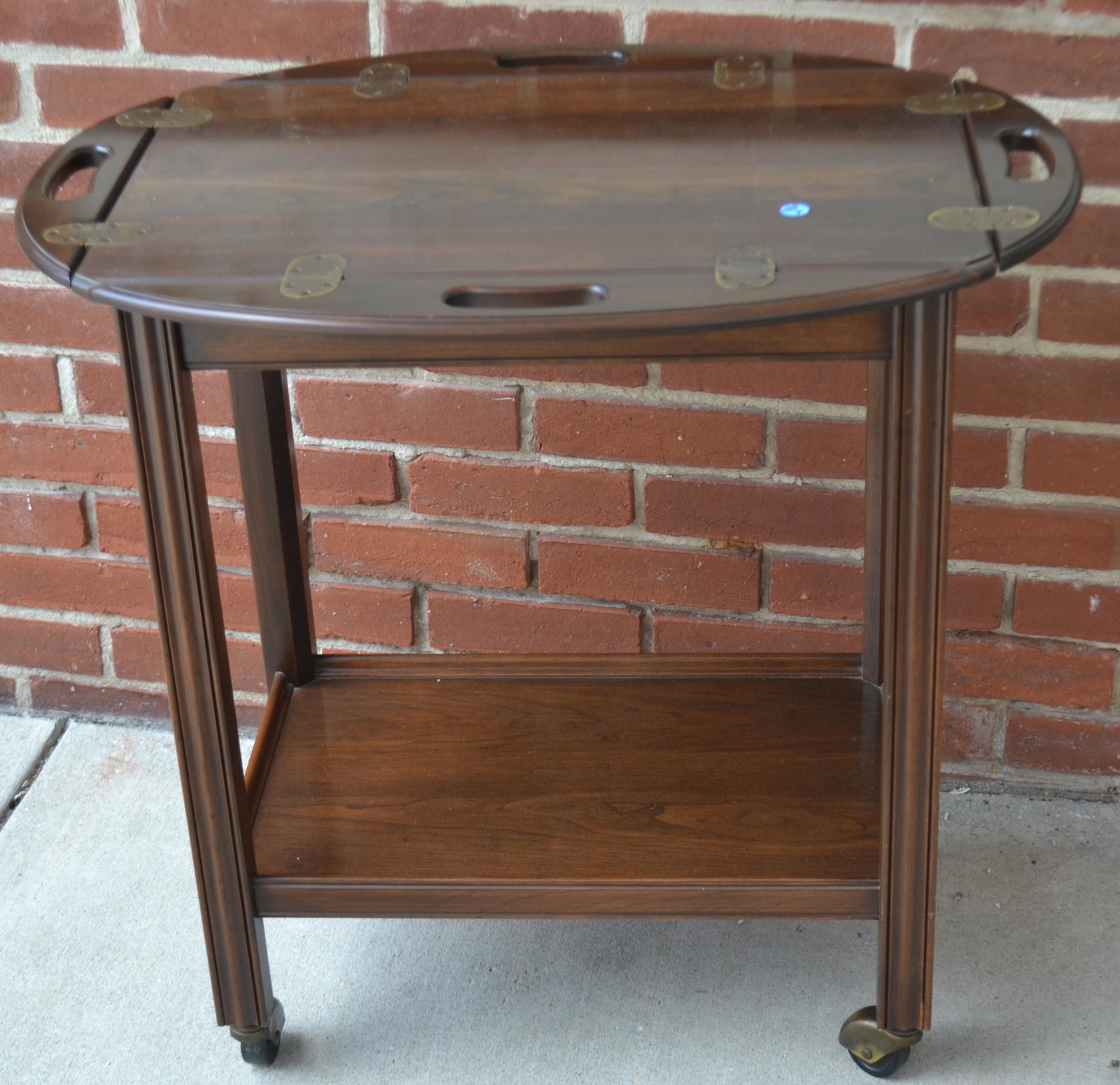 Butler's Tea Cart: Item measures approximately 31"H x 16"W x 24D. It is mahogany construction with brass hardware.