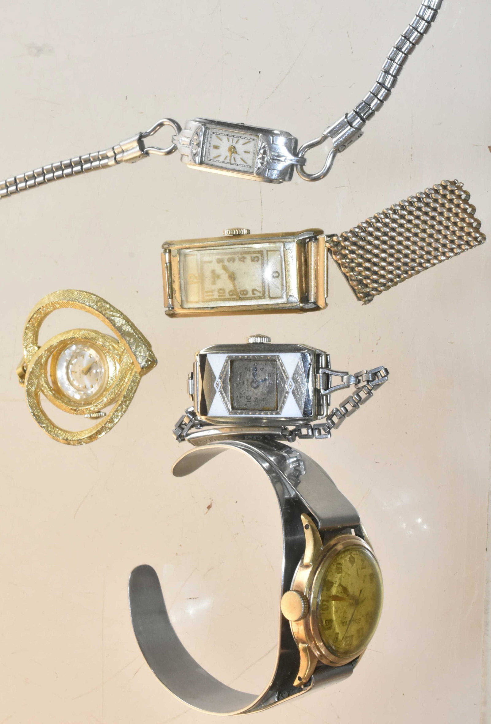 Grouping of Vintage Watches: Lot includes ladies' Vulcan pendant watch marked Swiss, delicate ladies' watch marked Swiss missing knob, an Elgin Star, a Bulova, and an Art Deco ladies' wristwatch with scratched crystal.