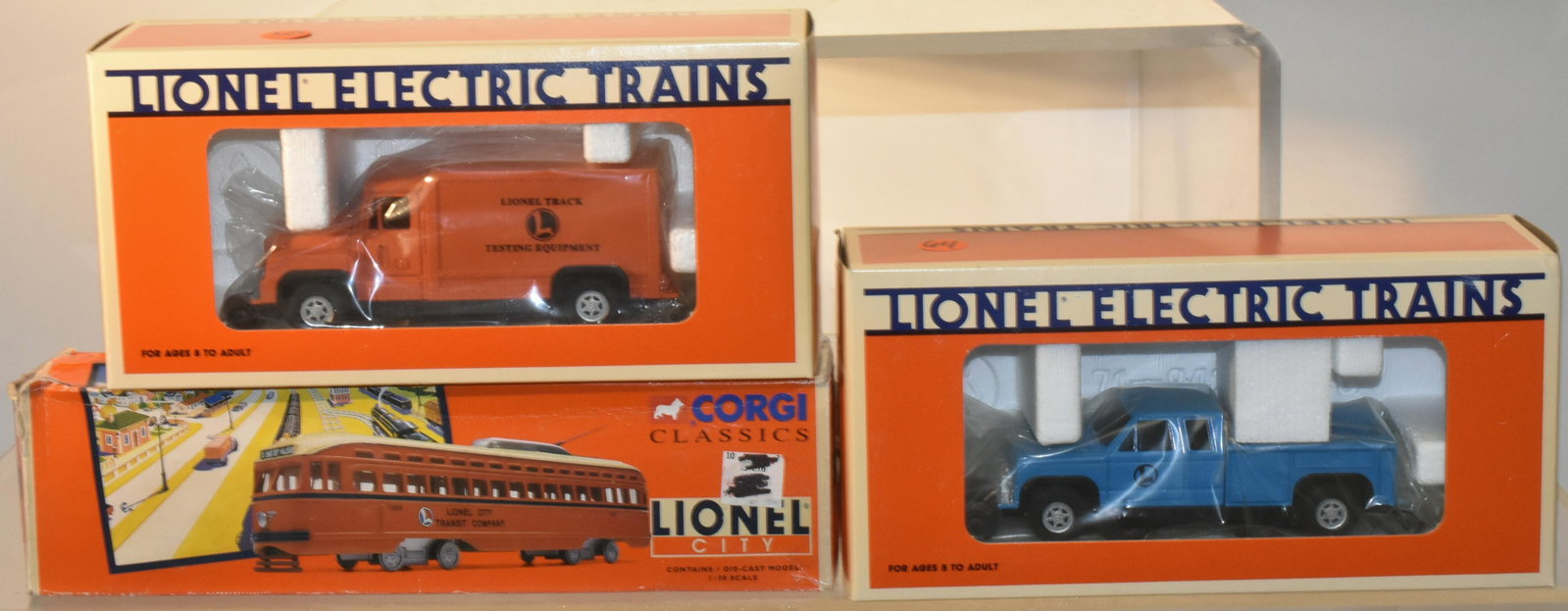 Lionel Vehicle Grouping: Lot includes a Lionel Corgi, die cast city transit vehicle, a Lionel 6-18423 step van, and a Lionel 6-18424 pick up truck.