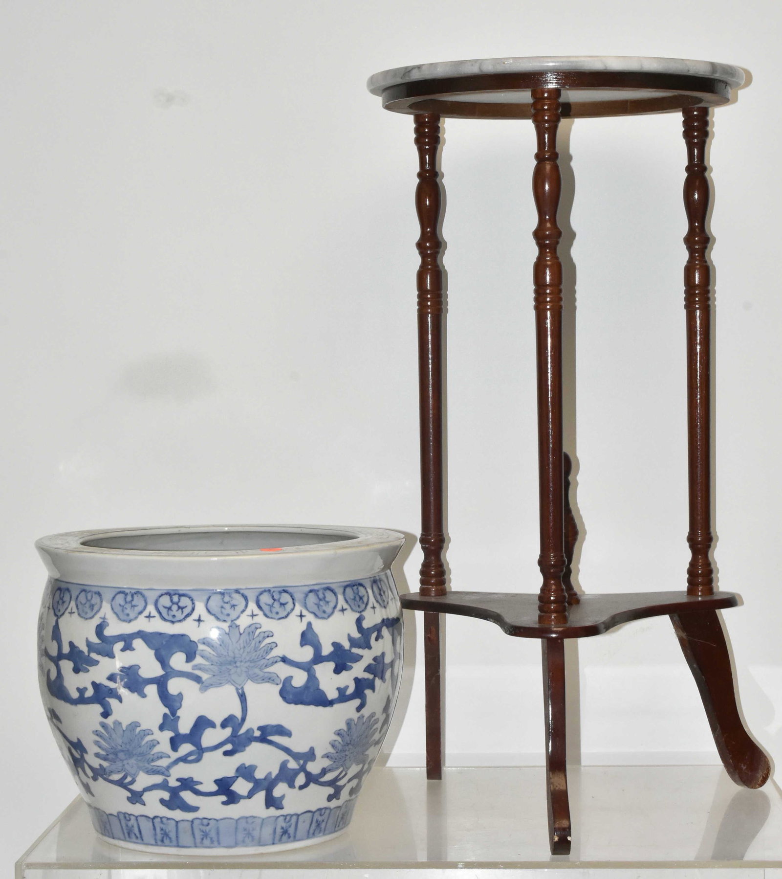 Plant Stand and a Fish Bowl: Lot includes a plant stand with marble top (27"H), and a Chinese Canton style fish bowl (10.5"H). Table top has scratches.