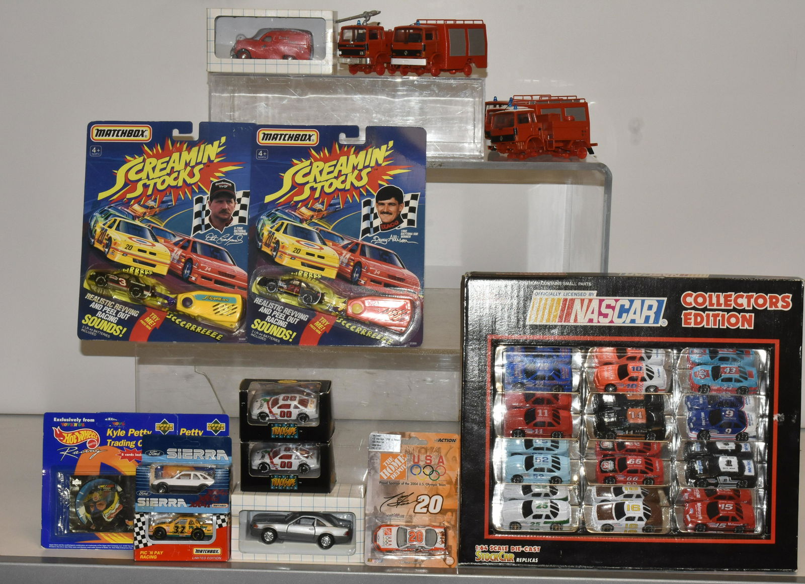 Mixed Toy Vehicle Collection: Lot includes NASCAR 12-piece Racing Champions set, Matchbox Screaming stock cars, other vehicles in pack, and die cast firetrucks in as found condition.