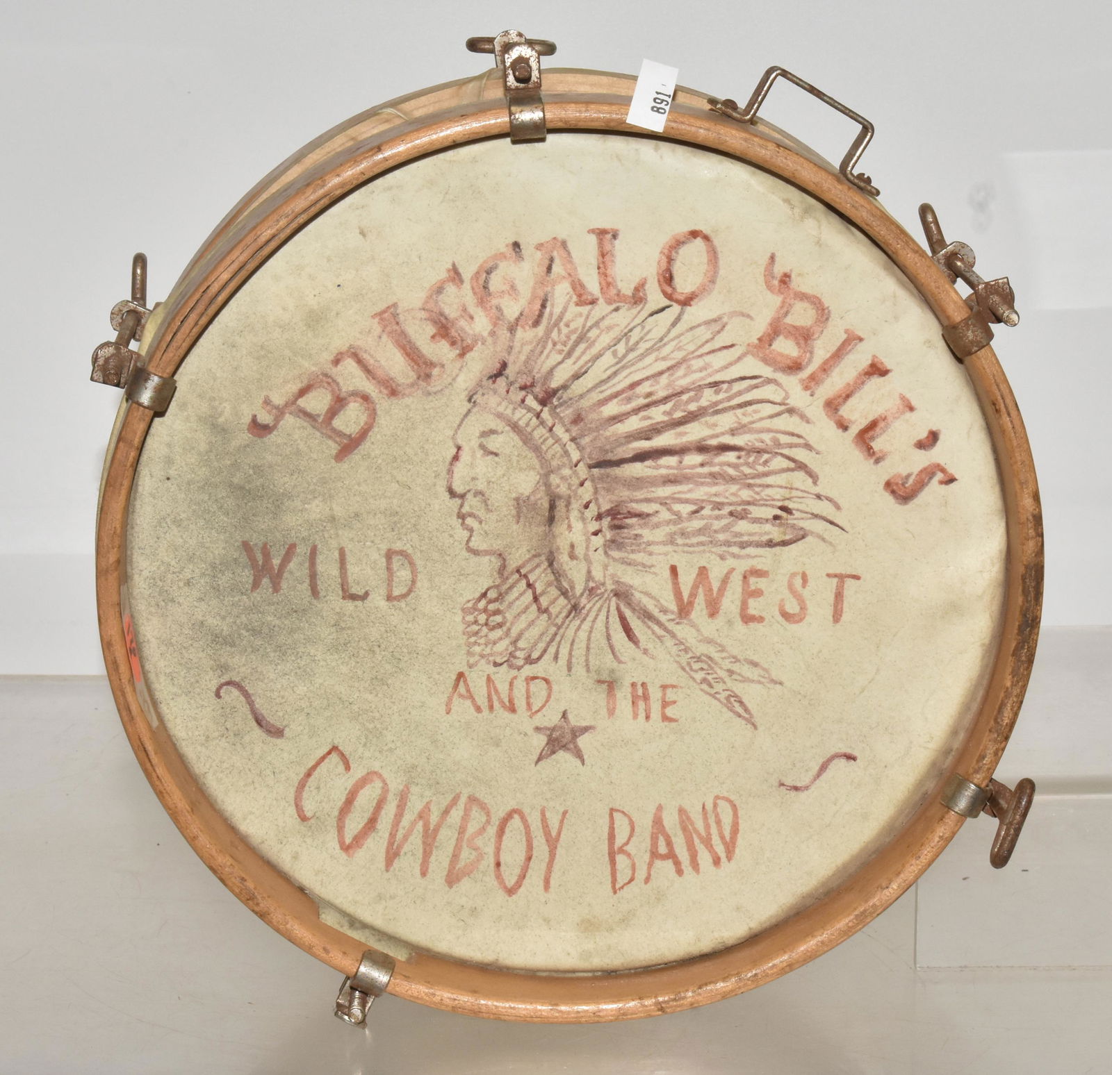 Child's Buffalo Bill Wild West Drum: Measures 10" diameter. It has a wood and chrome frame, one side reads "Buffalo Bill's Wild West", with (2) Buffalo original graphics. The other side has hand done graphics, with a Native American Chie