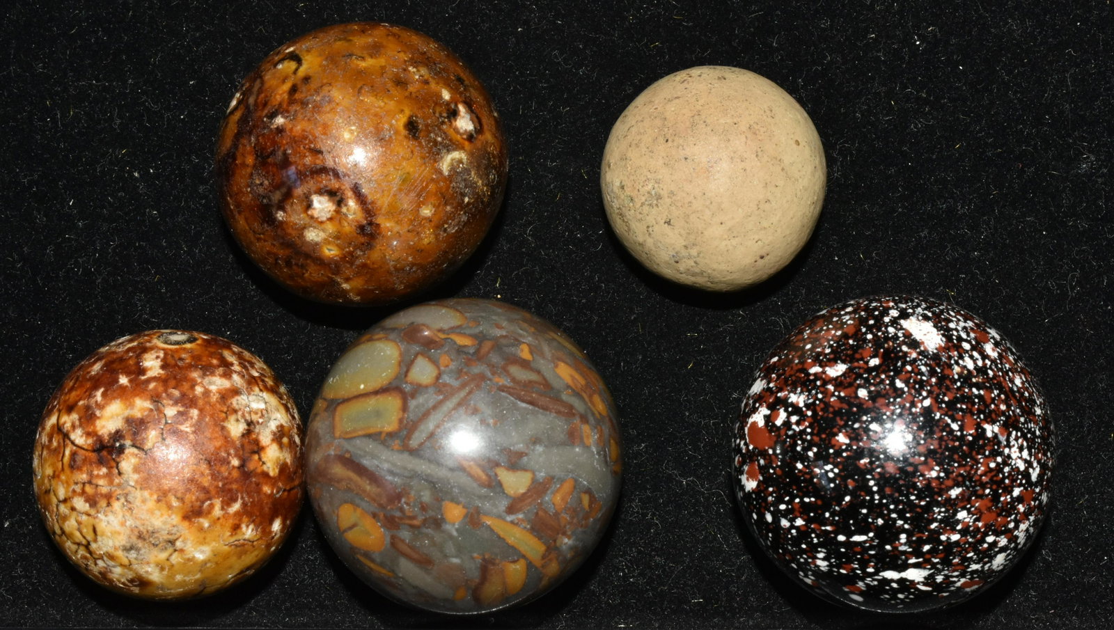 Oversized Clay and Other Marbles: Lot includes (3) clay marbles, largest measuring approximately 1 3/8" diameter. There is a marble with speckled exterior that may be clay, and a polished stone marble.