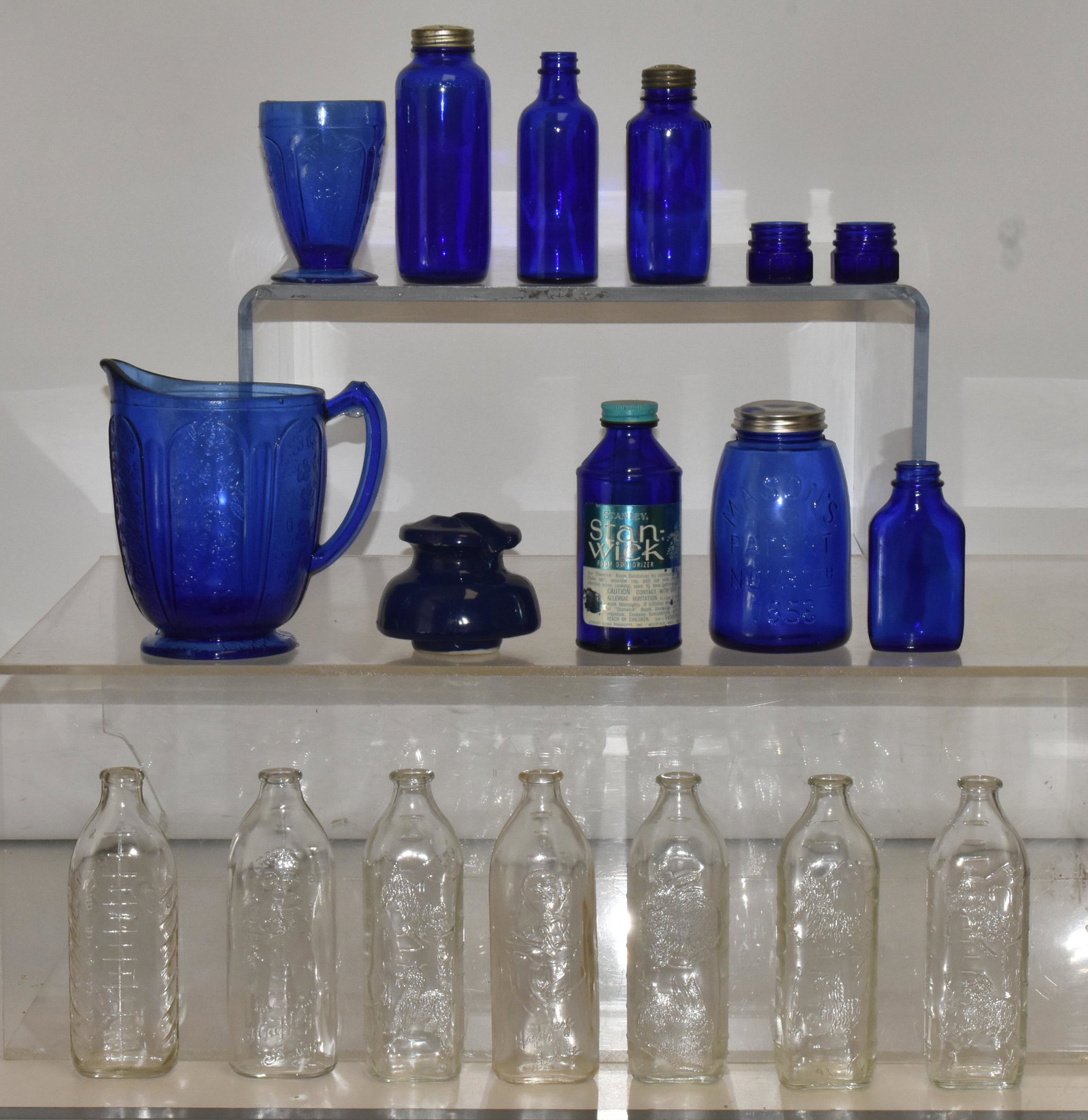 Cobalt Glass and Baby Bottles: Lot includes cobalt water pitcher, various cobalt bottles, (2) with sifter tops, a blue insulator, and (7) baby bottles with graphics.