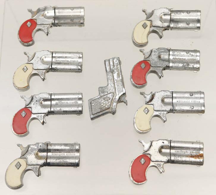 Double Derringer Cap Pistols: Lot includes (8) Double Derringer cap pistols, and (1) Trooper cap pistol with oxidation. Items come in latching in case.