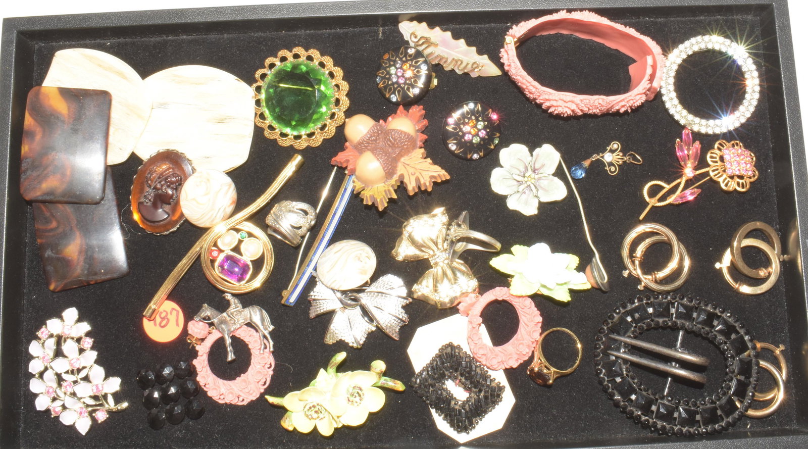 Designer and Other Costume Jewelry: Lot includes silver tone Trifari leaf pin, lavender Coventry brooch with pink rhinestones, (2) English Staffordshire floral pins, brooch with large faceted green stone (marked Germany), lavaliere with