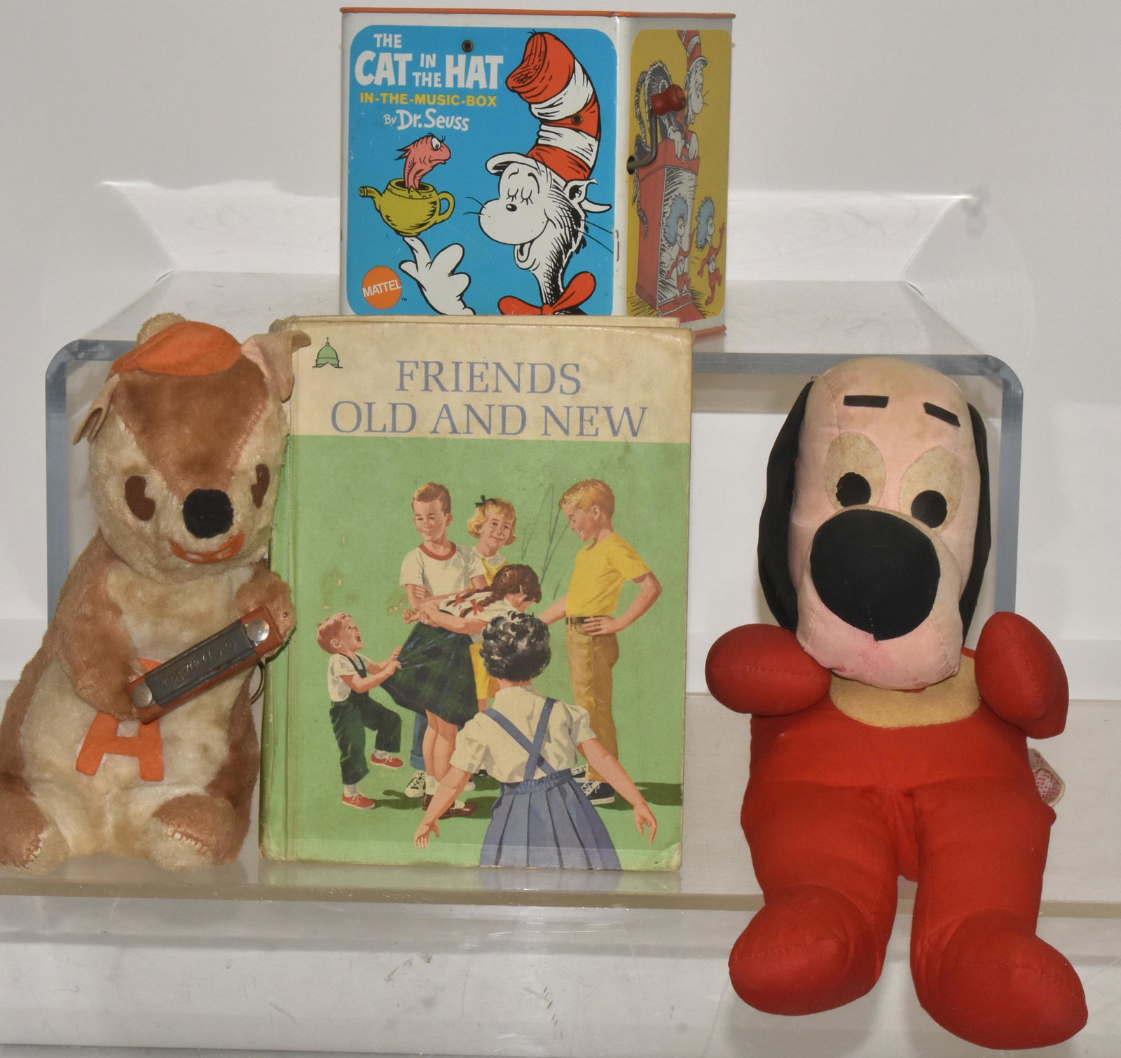 Cat in the Hat, Underdog, and Other Toys: Lot includes a Mattel Cat in the Hat Jack in the Box, an Underdog stuffed toy, a stuffed musical box squirrel with harmonica, and a book titled "Friends Old and New".