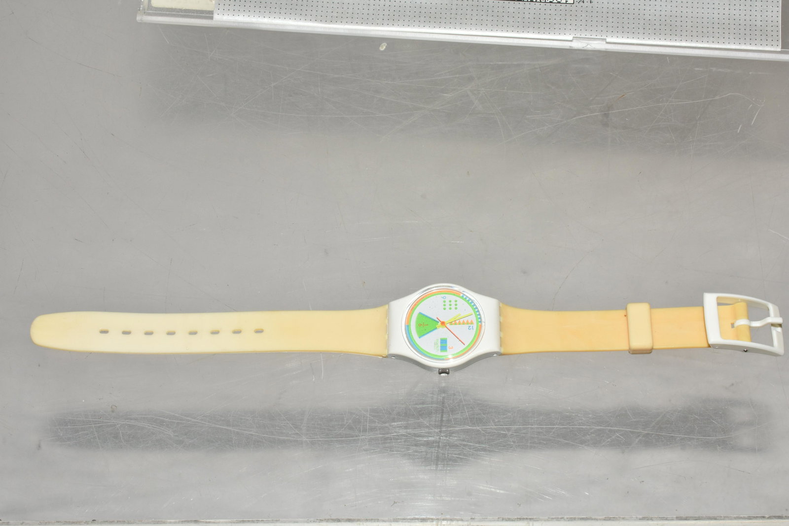 Swiss Made Swatch NIP: Cream colored band. Multicolor face. Dated 1988.