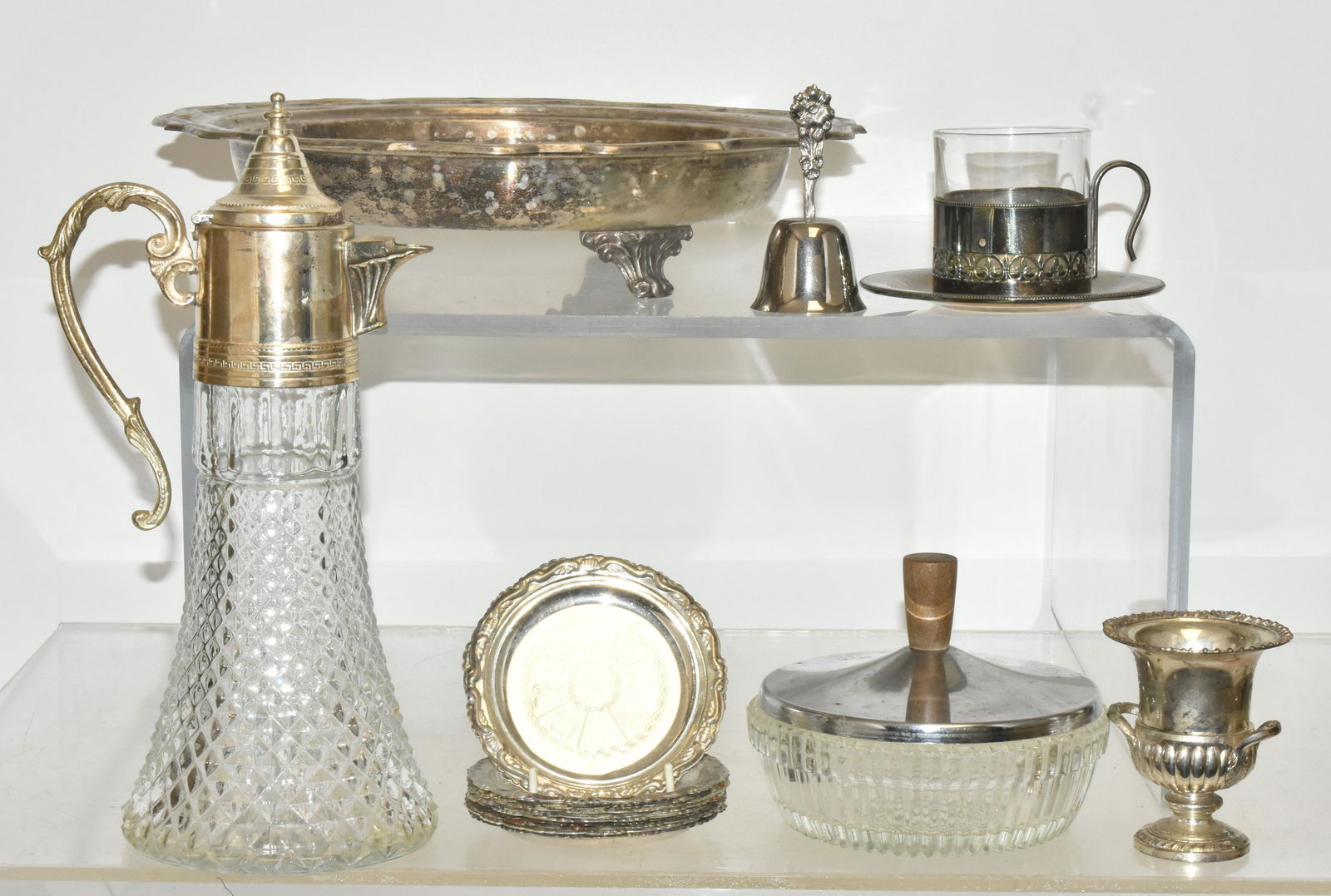 Silver Plated Wine Pitcher and Other Silver Plate: Lot includes a silver plated and glass wine pitcher (12"H), an Eals round silver plated footed tray, a set of (12) Italian silver plate coasters, silver plate and glass child cup and saucer, and other