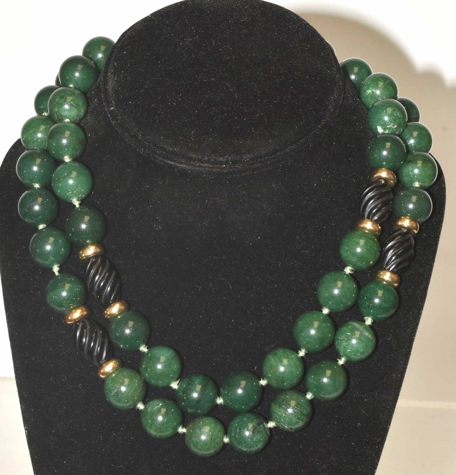 Jadeite and Onyx Necklace: Approximately 34". Jadeite beads, carved onyx, and gold tone spacers.