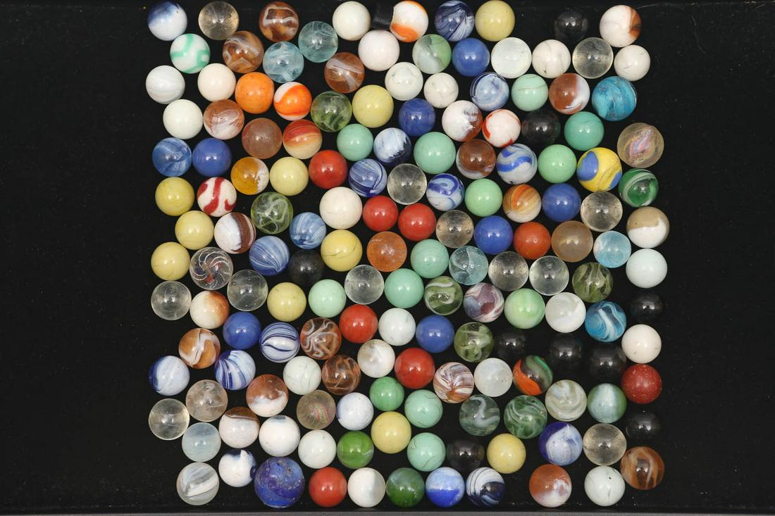 Grouping of Vintage Marbles: Lot includes three Latticino swirl marbles, multi colored swirl marbles and clearies. Items show common wear due to age and usage.