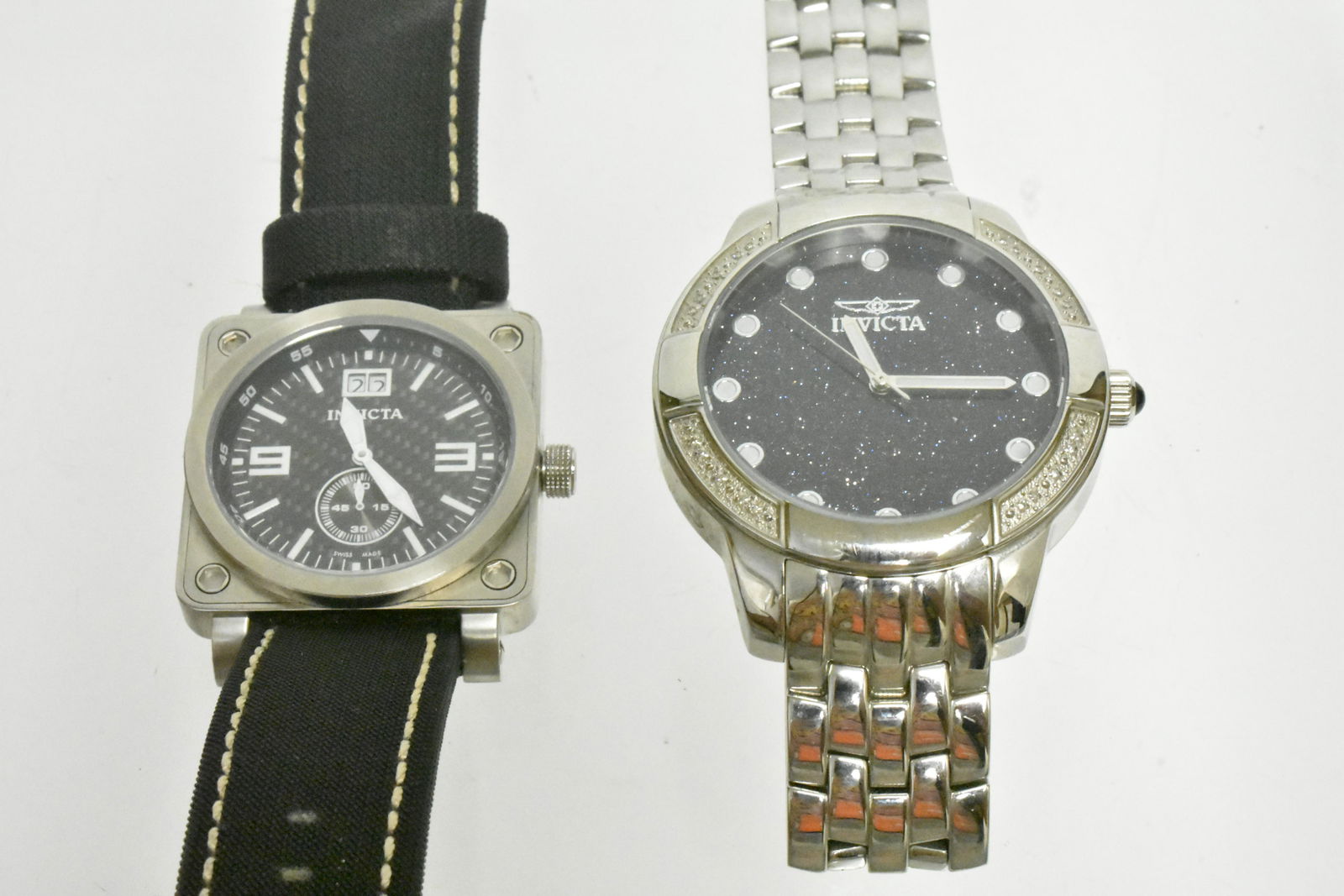 Invicta Watches: First watch is an all stainless steel. Flame fusion crystal, Swiss movement battery watch (I.D#0049). Watch reads â€œInvicta” on front and back, has three hands, and is water resistant (100M