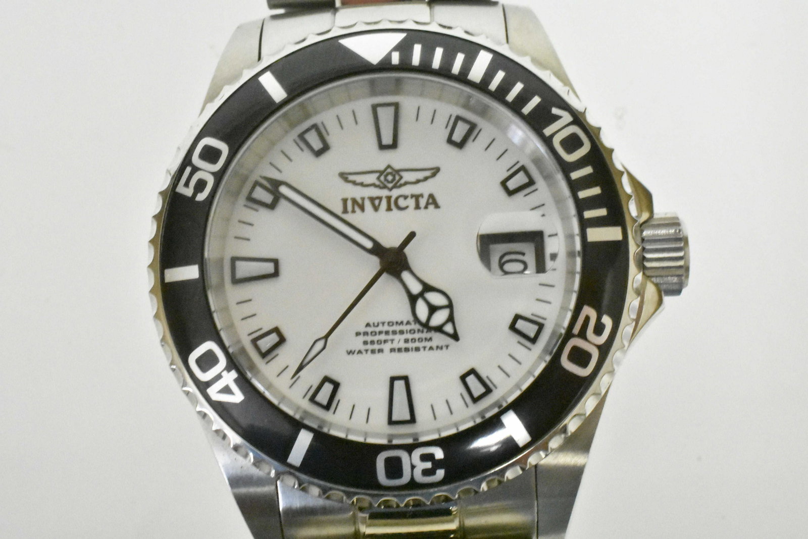 Invicta Watch: Watch has an automatic movement and is all stainless steel. Watch says â€œFlame-Fusion Crystal” on back of case, and is water resistant (200M). Watch is a Japan movement, and shows all three
