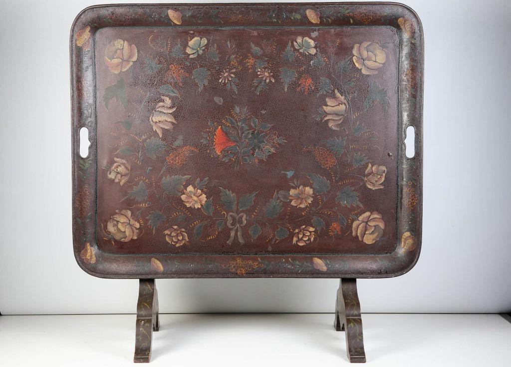 Russian Tole Painted Tray Table: Approximately 21"H x 34"W x 26.5"D. Toile painted tin tray top with floral motif. Wooden body with floral painting. Marked on back "Made in Russia. 2724".