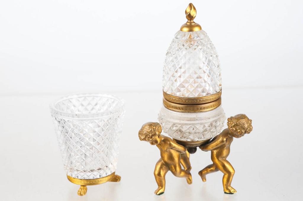 Figural French Inkwell and Pen Holder: Inkwell approximately 7.5"H. Geometric glass with brass mount and putti figures at base. Matching pen holder (3.25"H). Inkwell missing insert.