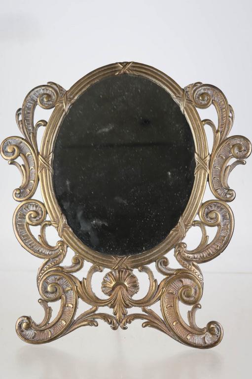 P.L. & B Co. Brass Table Mirror: Approximately 14.5"H. Solid brass body with original stand. Company marking on back.