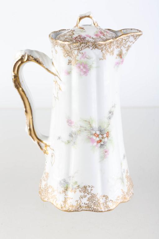 Theodore Haviland Limoges France Chocolate Pot: Approximately 8"H. Floral decoration with scattered gold flashing. Free of chips and cracks. Marked Theodore Haviland, Limoges France under lid and bottom.