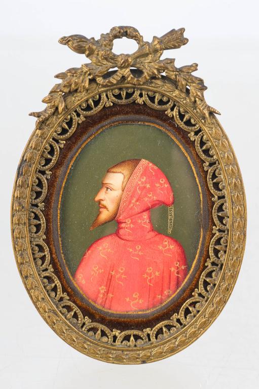 Hand Painted French Miniature Portrait, 19th C: Frame approximately 4"H x 3"W. 19th. Solid brass with ornate design. Marked France in banner on back. Original back stand. Contains hand painted portrait of gentleman with a beard in red robe.
