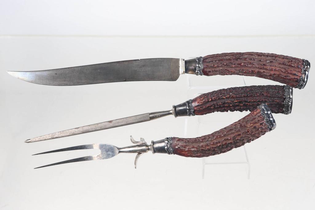 Landers Black Forest Style Carving Set, 19th C: includes 3-piece set with knife, meat fork and sharpening steel. Carving knife approximately 15.75"L. Blade reads "Landers, Fray & Clark. Aetna Works". Monogrammed D on butt on silver mounts. Antler h