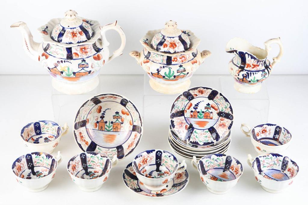 Gaudy Welsh Village Pattern Tea Set: includes teapot (8"H), sucree (7"H), a cream pitcher, a large waste bowl, and (8) cups and saucers, free of visible flaws. Cream pitcher has a minor crow's foot on bottom. Sucree has chips to interior