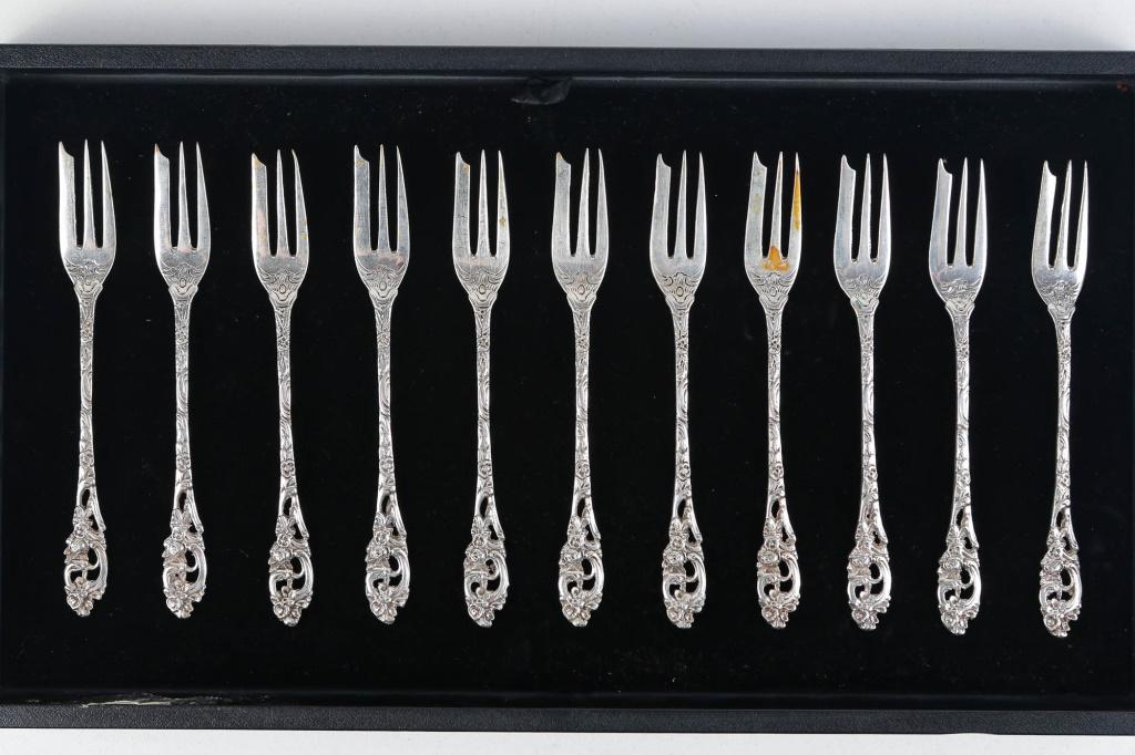 .800 Silver Dessert Forks (Set of 11): Each measures approximately 6"L. Forks have an ornate pattern and are marked .800 with a crown symbol. Total weight approximately 217 grams. 6.97 ozt.