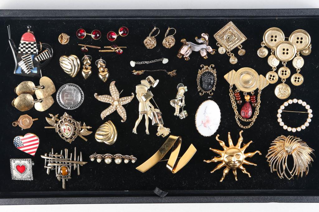 Mixed Costume Jewelry: includes a Monet Fireworks brooch, a smiling sun brooch, a cameo, and gold tone jewelry.