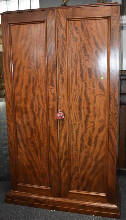 19th Century English Linen Press: crotch grain mahogany construction with fitted interior/drawers, the cabinet breaks down into two sections, doors one piece.