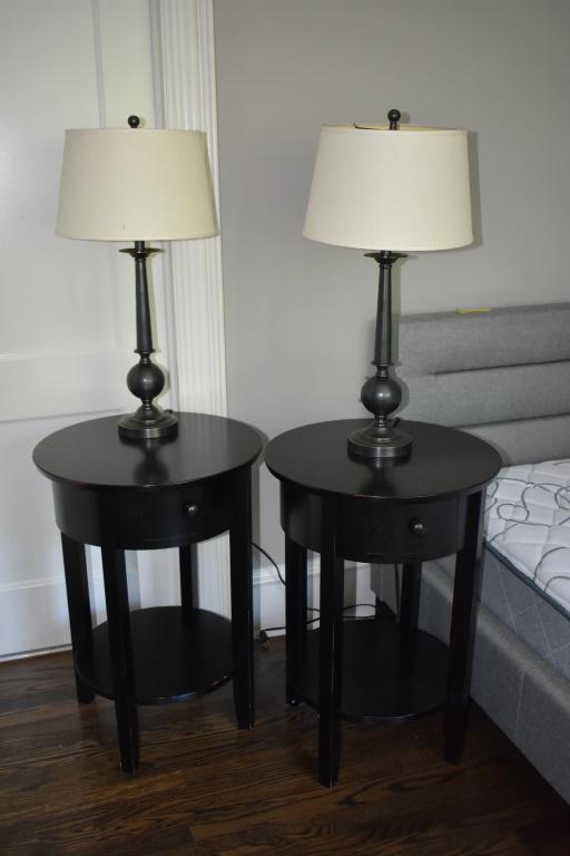 Pottery Barn Grouping - Tables and Lamps: Two round black wood 1-drawer tables (nightstands) with matching lamps. * NOTE: This item is located in our Chestnut Hill/Philadelphia location. Available for pick up at that warehouse by appointment.