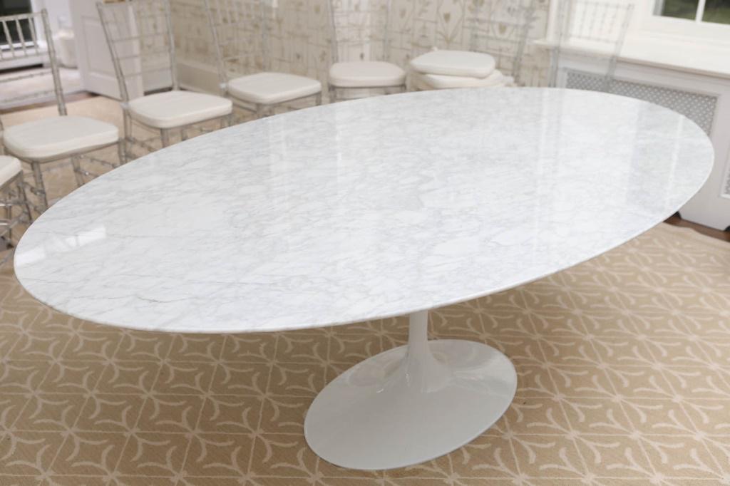 "Noll" Style Tulip Dining Table in White: Table measures approximately 29"H x 79"L x 48"W. Item has a tulip pattern. In the style of "Noll". White marble-like top, heavy like a stone material. * NOTE: This item is located in our Chestnut Hill