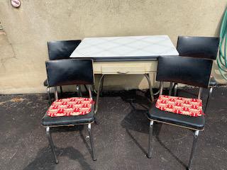 Mid Century Table and Chairs: includes an enameled top table with a drawer, and four black and chrome chairs set needs to be cleaned