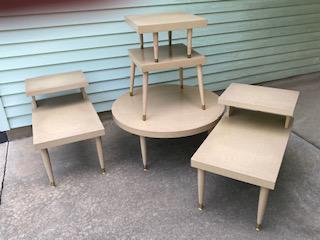 Four Pieces of Mid Century Furniture: includes a round coffee table, two end tables, and a two-tier plant stand.