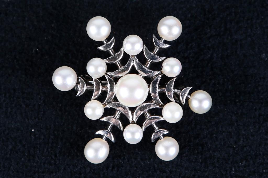 Vintage "Mikimoto" Sterling and Pearl Brooch: Brooch has a snowflake design with 13 pearls and sterling body. Signed "Mikimoto Tokyo Silver".
