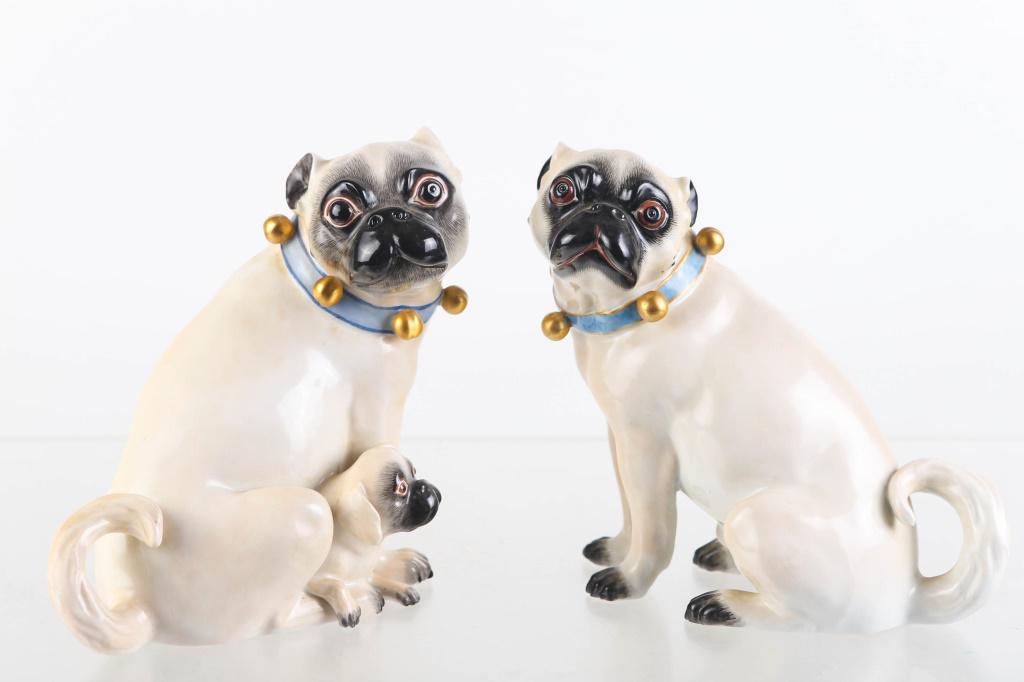 Pair of Meissen Pug Dog Figures: Each measures approximately 7.5"H . The female has a puppy by her side. Both are well executed and have Meissen marks.