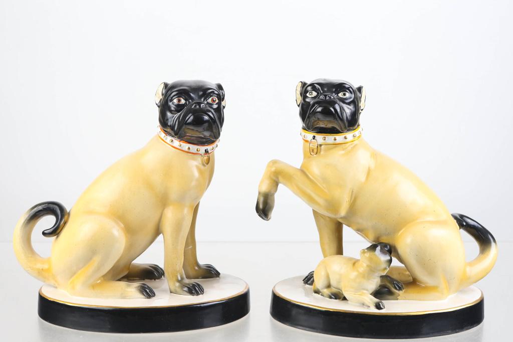 Pair of Mottahedeh Seated Pug Dogs: Each measures approximately 9"H. The female has a suckling puppy. Both retain paper label.