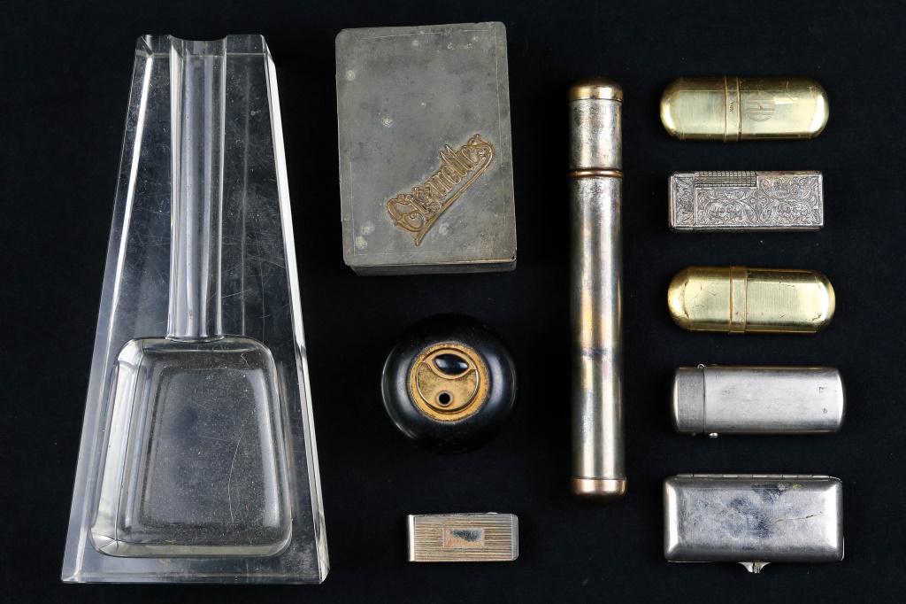 Early 20th C Lighters and Smoking Accessories: includes (4) vintage lighters (one is a desktop lighter marked Colibri Japan), an embossed body lighter marked Zamia, Japan, and (2) brass body Japanese lighters. Lot also includes a brass and silver 