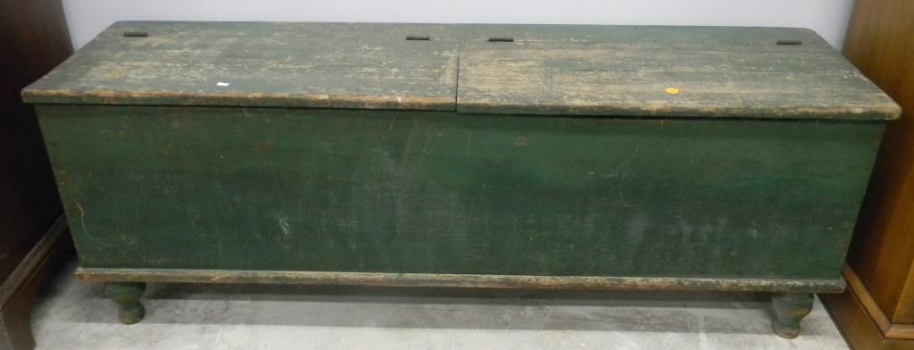 19th C Wood Box in Green Paint: Item measures approximately 19"H x 55"W x 16"D. It is a double lid wood box, it is pine construction, and it is on a turned foot.